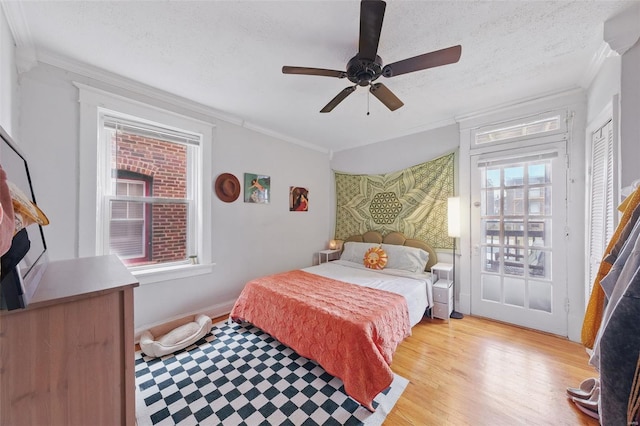 5044 Lindenwood Ave, Saint Louis, MO 63109 - bedroom featuring crown molding, a textured ceiling, light wood-style flooring, and ceiling fan