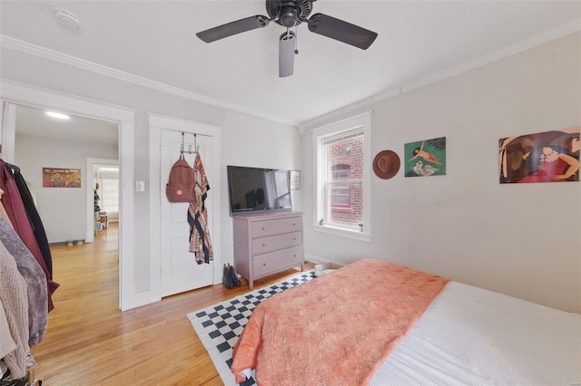 5044 Lindenwood Ave, Saint Louis, MO 63109 - bedroom with multiple windows, crown molding, light wood finished floors, ceiling fan, and baseboards