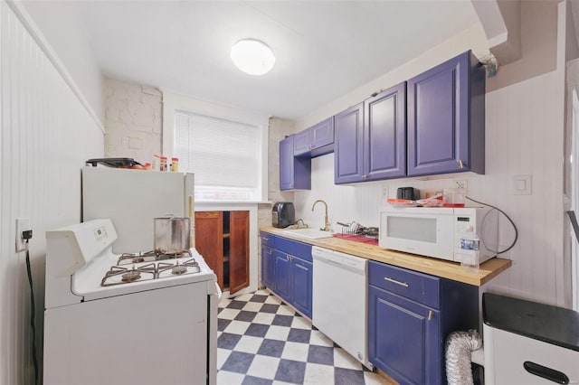 5044 Lindenwood Ave, Saint Louis, MO 63109 - kitchen with white appliances, a sink, blue cabinetry, light flooring, and butcher block countertops