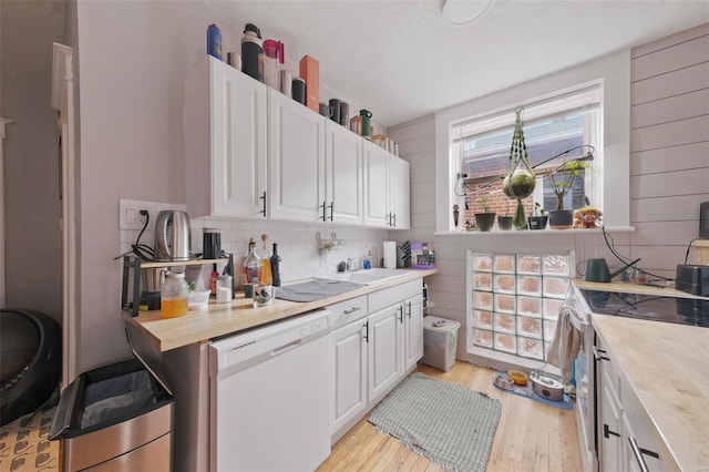 5044 Lindenwood Ave, Saint Louis, MO 63109 - kitchen featuring white appliances, light wood-type flooring, white cabinets, backsplash, and butcher block counters