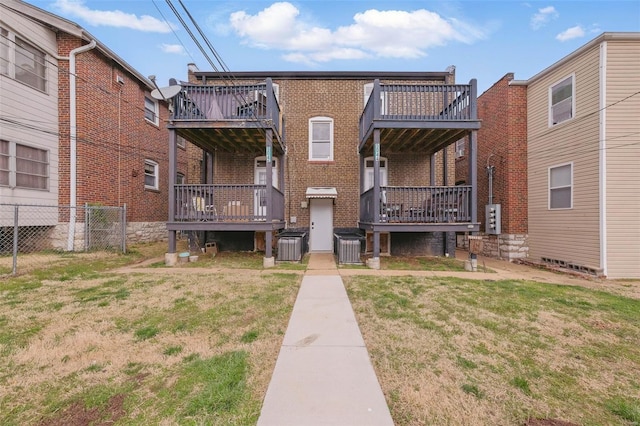 5044 Lindenwood Ave, Saint Louis, MO 63109 - back of house featuring brick siding, a wooden deck, and central AC