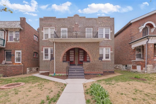 5044 Lindenwood Ave, Saint Louis, MO 63109 - view of front facade featuring covered porch, brick siding, a balcony, and a front lawn