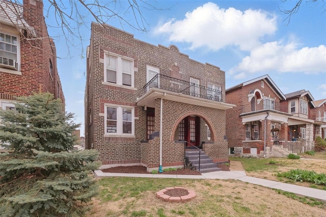 5044 Lindenwood Ave, Saint Louis, MO 63109 - view of front of home with a balcony, brick siding, and a fire pit