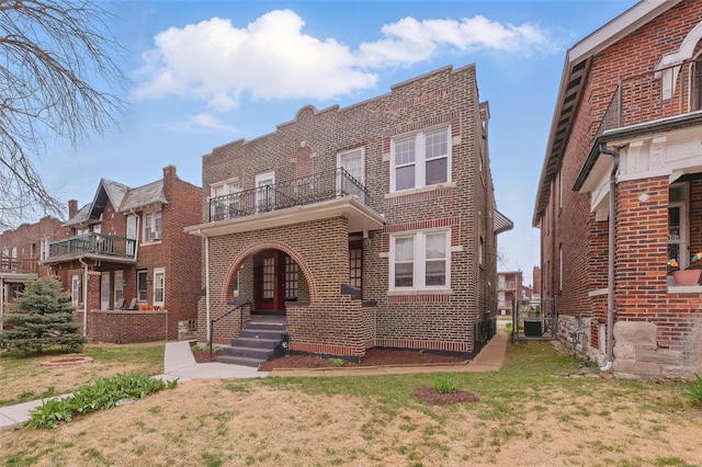 5044 Lindenwood Ave, Saint Louis, MO 63109 - view of front of home with brick siding, a balcony, and a front yard