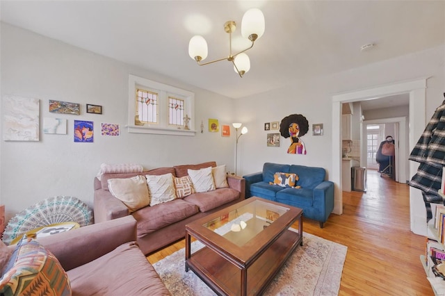 5044 Lindenwood Ave, Saint Louis, MO 63109 - living area with a chandelier and light wood-style flooring