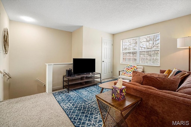 carpeted living room with a textured ceiling and baseboards