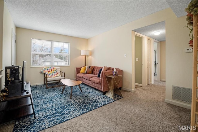 carpeted living area featuring a textured ceiling and baseboards