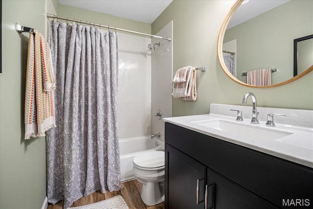 full bath with wood finished floors, toilet, vanity, and shower / bath combo with shower curtain
