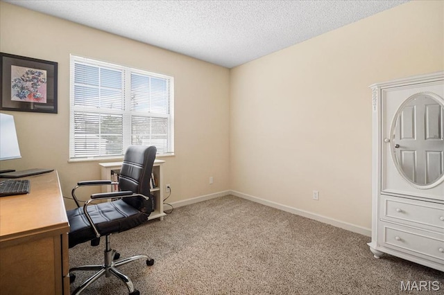 office space with carpet floors, a textured ceiling, and baseboards