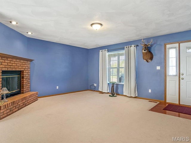 100 Fairway Dr, Waterloo, IL 62298 - unfurnished living room featuring baseboards, carpet, and a brick fireplace