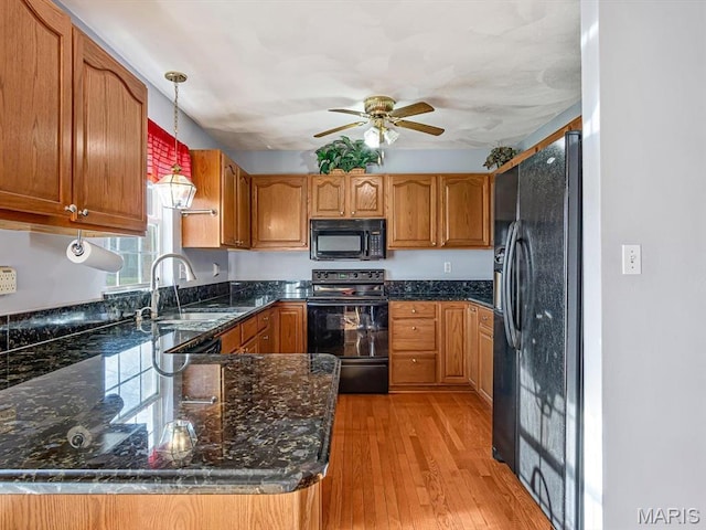 100 Fairway Dr, Waterloo, IL 62298 - kitchen with black appliances, a ceiling fan, a sink, pendant lighting, and a peninsula
