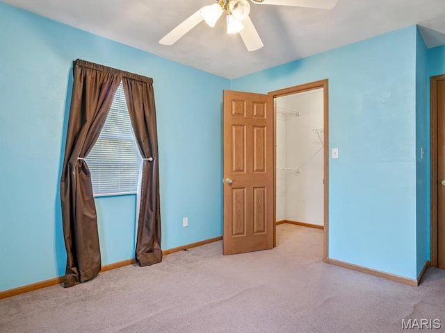 100 Fairway Dr, Waterloo, IL 62298 - unfurnished bedroom with carpet floors, baseboards, a walk in closet, and a ceiling fan