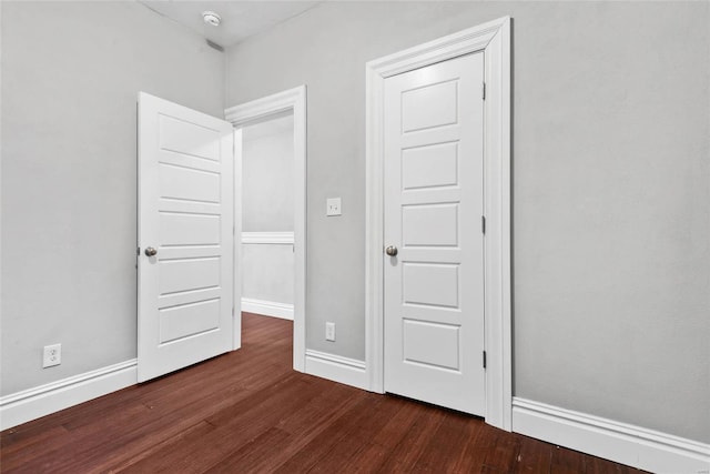 2714 Texas Ave, Saint Louis, MO 63118 - unfurnished bedroom featuring dark wood finished floors and baseboards