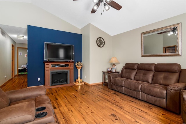 15919 Candy Corner Ln, Carlyle, IL 62231 - living area featuring ceiling fan, wood finished floors, vaulted ceiling, a fireplace, and baseboards