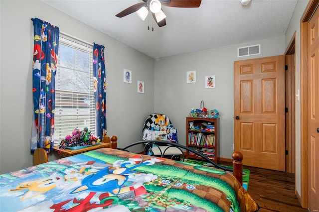 15919 Candy Corner Ln, Carlyle, IL 62231 - bedroom with wood finished floors, ceiling fan, and a textured ceiling