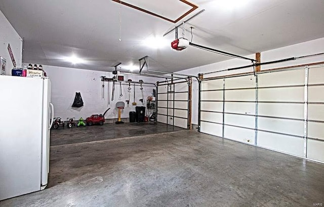 15919 Candy Corner Ln, Carlyle, IL 62231 - garage featuring freestanding refrigerator and a garage door opener