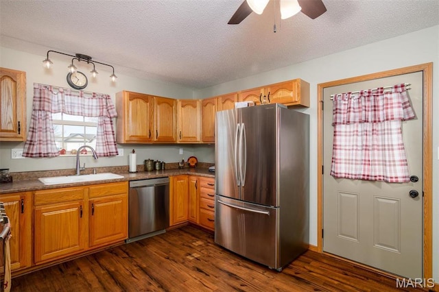 15919 Candy Corner Ln, Carlyle, IL 62231 - kitchen featuring appliances with stainless steel finishes, dark wood-type flooring, a ceiling fan, a textured ceiling, and dark countertops