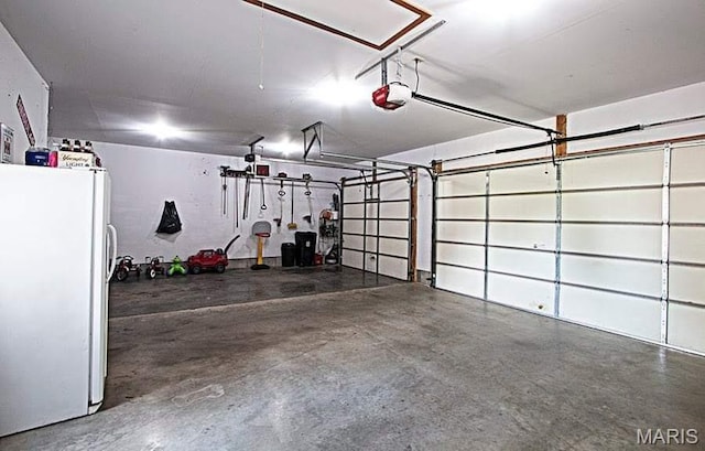 15919 Candy Corner Ln, Carlyle, IL 62231 - garage with freestanding refrigerator and a garage door opener