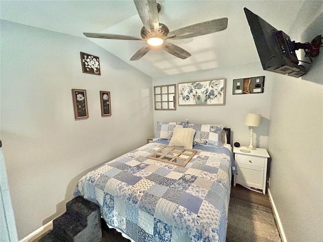 bedroom with vaulted ceiling, baseboards, a ceiling fan, and dark carpet