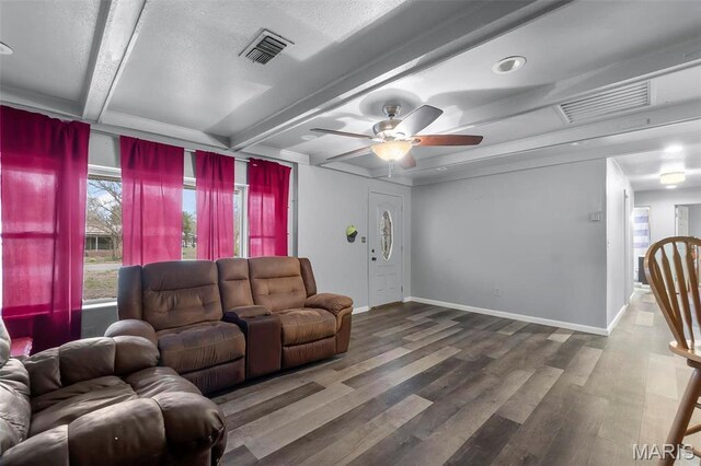 307 E Clark St, Clarkton, MO 63837 - living area with wood finished floors, beam ceiling, a ceiling fan, and baseboards