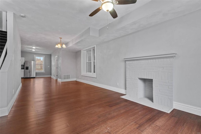 2716 Texas Ave, Saint Louis, MO 63118 - unfurnished living room featuring a chandelier, wood finished floors, a ceiling fan, and baseboards