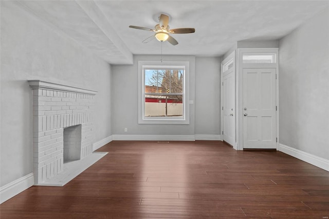 2716 Texas Ave, Saint Louis, MO 63118 - unfurnished living room featuring a ceiling fan, a brick fireplace, baseboards, and dark wood-style flooring