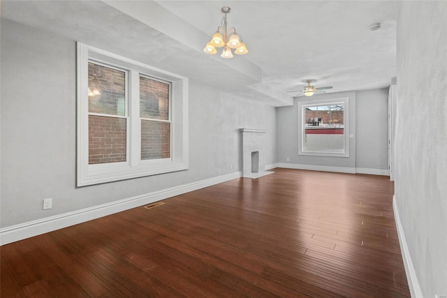 2716 Texas Ave, Saint Louis, MO 63118 - unfurnished living room with wood finished floors, baseboards, a chandelier, ceiling fan, and a brick fireplace