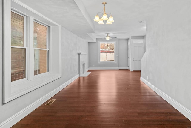 2716 Texas Ave, Saint Louis, MO 63118 - unfurnished dining area with a chandelier, wood finished floors, a fireplace, and baseboards