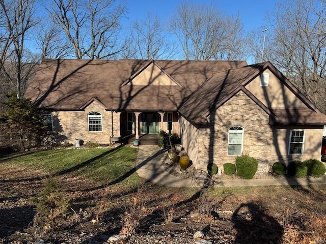 4072 Osage Rdg, House Springs, MO 63051 - view of front of house with covered porch, a front lawn, and brick siding