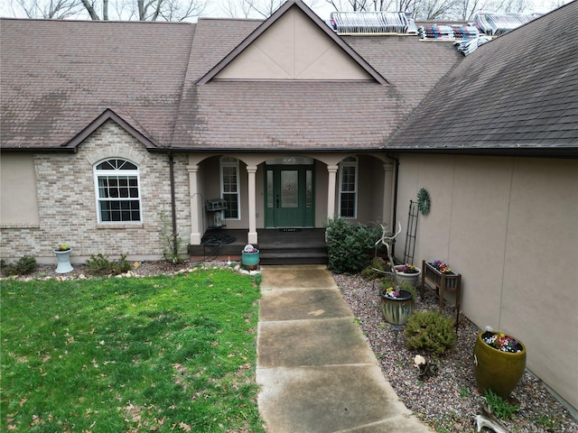 4072 Osage Rdg, House Springs, MO 63051 - property entrance with a porch, a shingled roof, a yard, and stucco siding