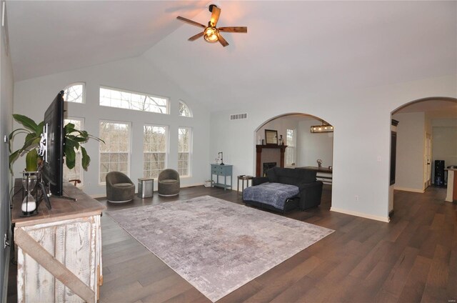 4072 Osage Rdg, House Springs, MO 63051 - living room featuring arched walkways, ceiling fan, high vaulted ceiling, dark wood-type flooring, and baseboards