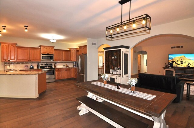 4072 Osage Rdg, House Springs, MO 63051 - dining area featuring arched walkways and dark wood finished floors