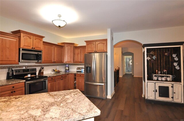4072 Osage Rdg, House Springs, MO 63051 - kitchen featuring stainless steel appliances, arched walkways, and brown cabinets