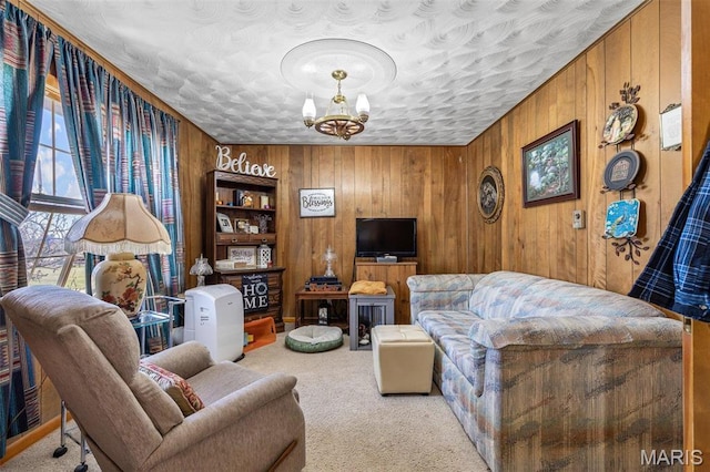 113 S Madison St, Desloge, MO 63601 - carpeted living room featuring a chandelier, wooden walls, and a textured ceiling