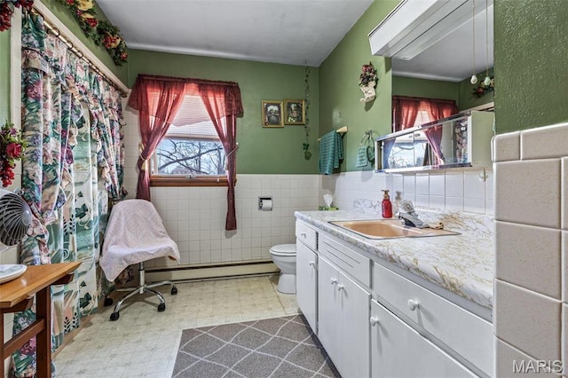 113 S Madison St, Desloge, MO 63601 - full bath with plenty of natural light, tile patterned floors, toilet, a baseboard radiator, and a wainscoted wall