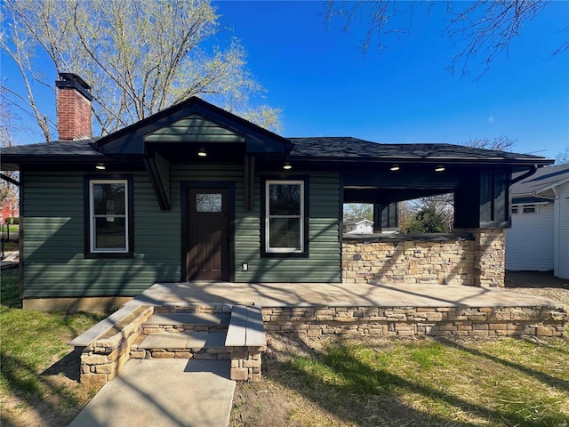 view of front of house featuring a chimney