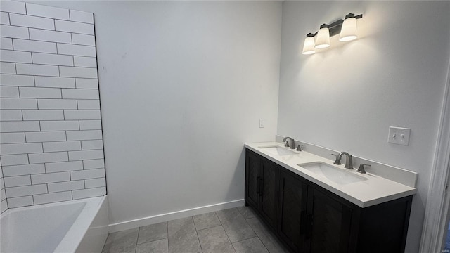 full bath featuring tile patterned flooring, double vanity, and baseboards