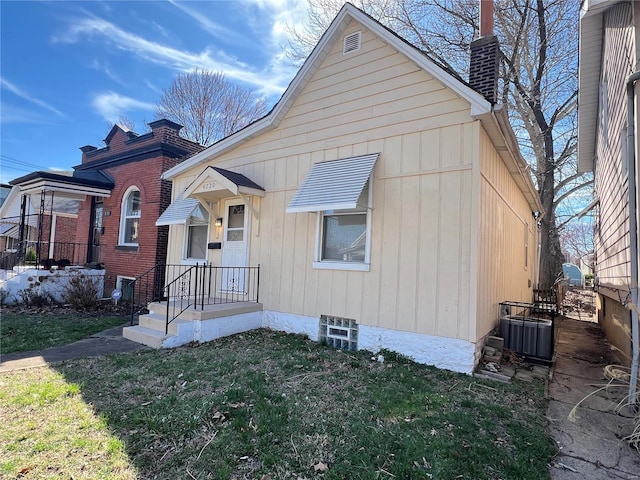 4720 Goethe Ave, Saint Louis, MO 63116 - bungalow-style house featuring central air condition unit, a chimney, and a front yard