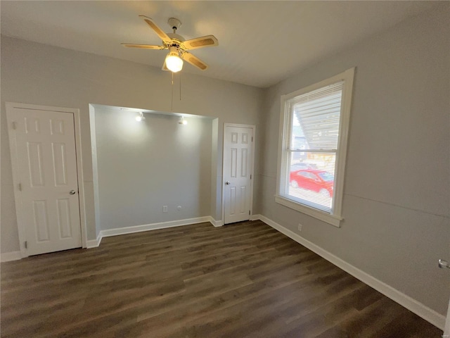 4720 Goethe Ave, Saint Louis, MO 63116 - unfurnished bedroom featuring dark wood finished floors, baseboards, and ceiling fan