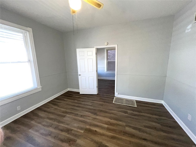 4720 Goethe Ave, Saint Louis, MO 63116 - unfurnished room featuring dark wood-type flooring, baseboards, and a ceiling fan