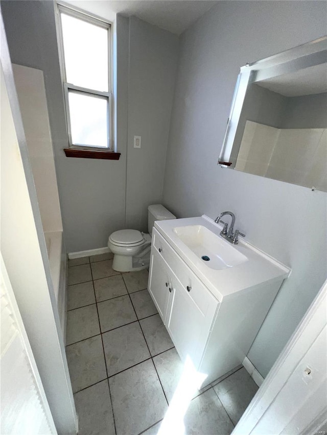 4720 Goethe Ave, Saint Louis, MO 63116 - full bath featuring vanity, toilet, tile patterned flooring, a shower, and baseboards