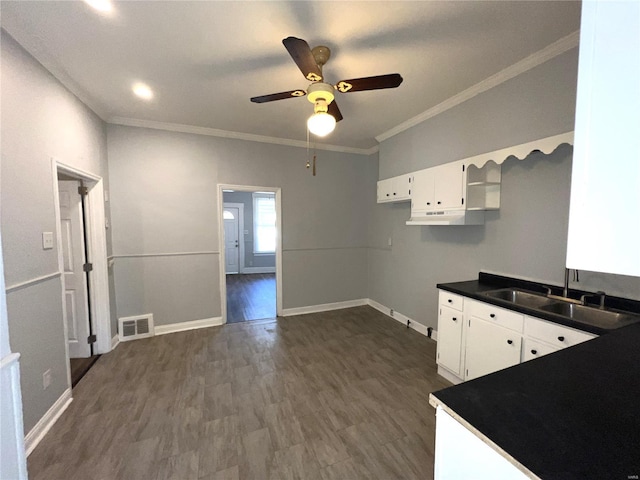 4720 Goethe Ave, Saint Louis, MO 63116 - kitchen featuring a sink, ceiling fan, dark countertops, white cabinetry, and baseboards