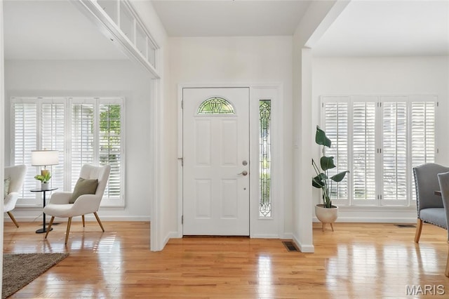 foyer featuring light wood-style floors and baseboards