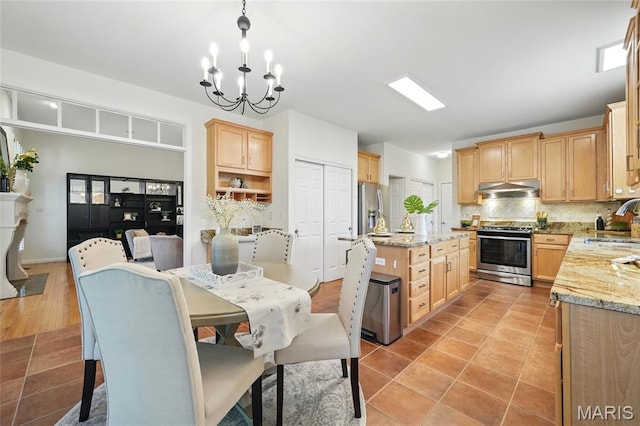 dining room with a chandelier and light tile patterned floors