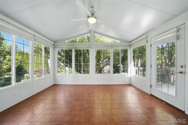 unfurnished sunroom with tile patterned floors, vaulted ceiling, and french doors