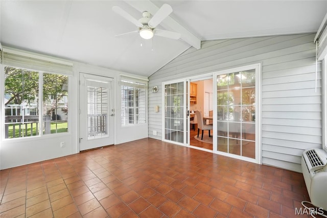 unfurnished sunroom featuring ceiling fan and wooden walls