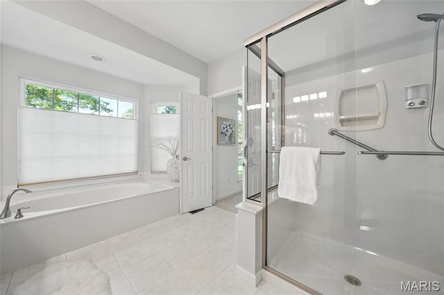 bathroom with a garden tub, a stall shower, and tile patterned floors