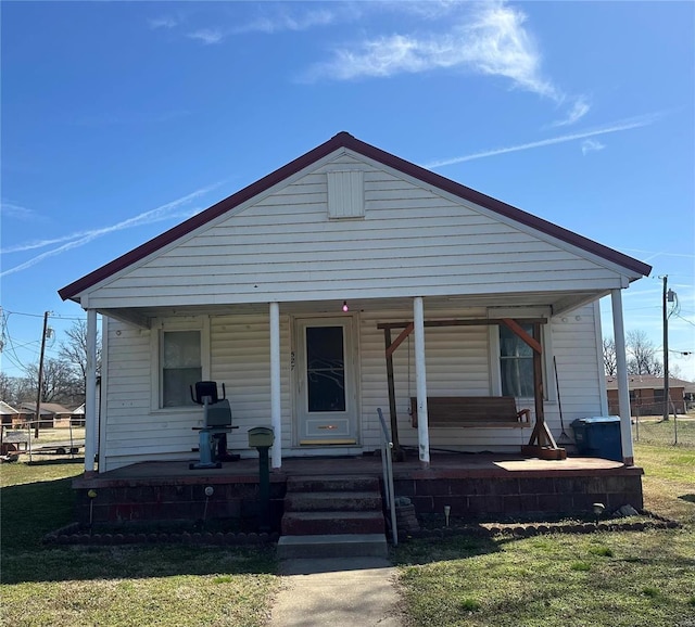 527 Main St, New Madrid, MO 63869 - view of front of property featuring covered porch and a front yard