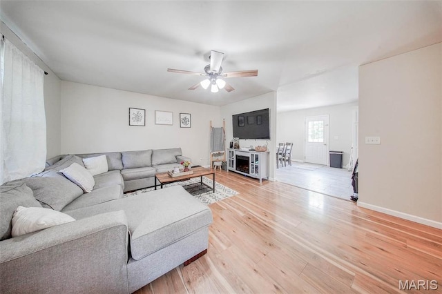 24478 Trolley Ln, Saint Robert, MO 65584 - living room featuring a ceiling fan, light wood-style floors, and baseboards