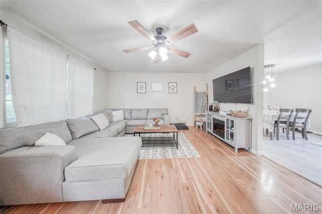 24478 Trolley Ln, Saint Robert, MO 65584 - living area with light wood-style flooring, ceiling fan, and healthy amount of natural light